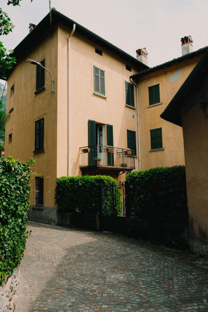 Scenic view of a classic European townhouse with a charming balcony and paved alley