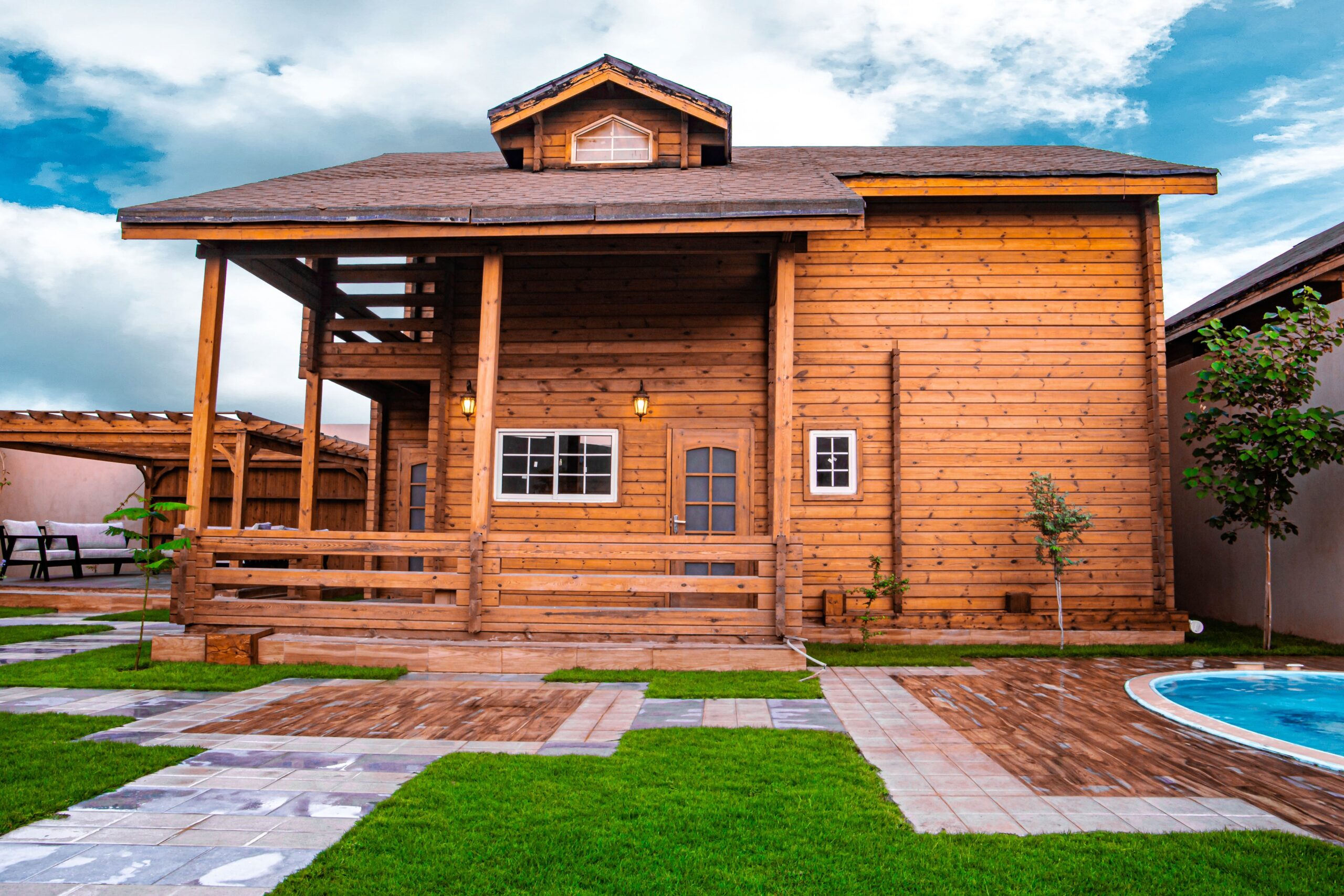 A picturesque wooden bungalow with a large porch, perfect for outdoor relaxation.
